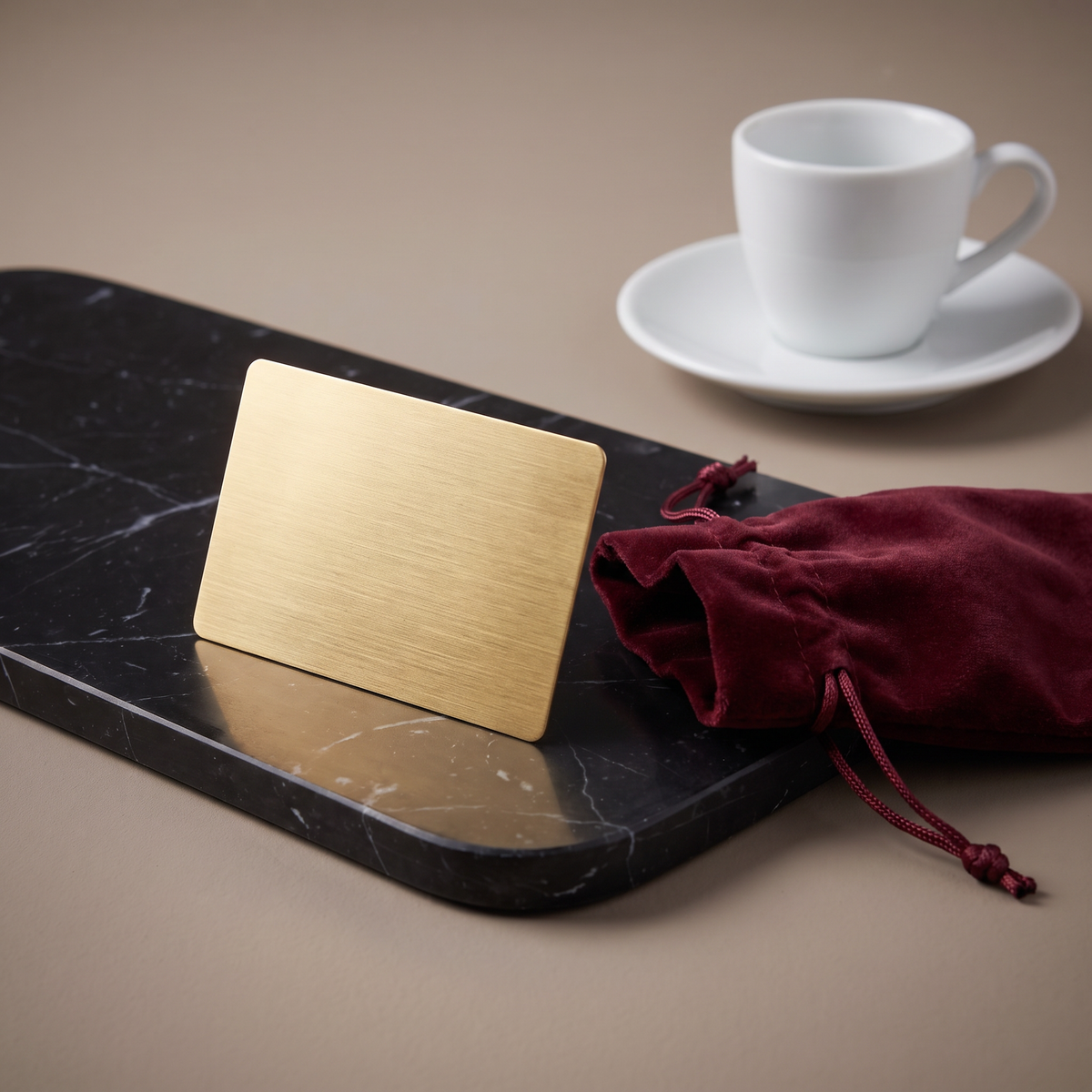 Casa Bugatti gift card in brushed gold with burgundy velvet pouch on black marble