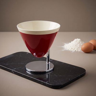 Casa Bugatti Uma kitchen scale, red bowl on chrome stem, on black marble with flour and eggs