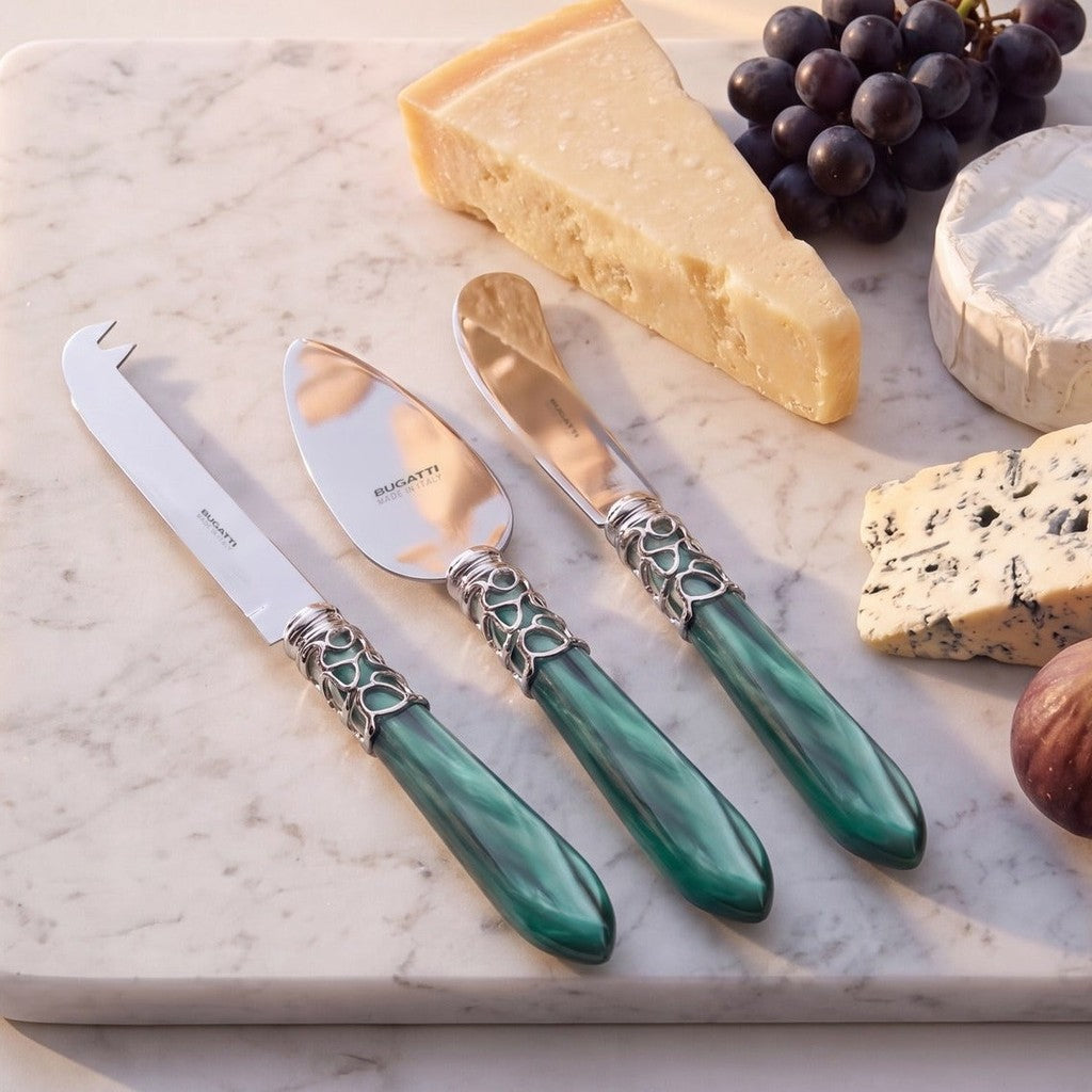Melodia Brilliant 3 piece cheese knife set, Emerald Green, on a marble cheese board — Casa Bugatti